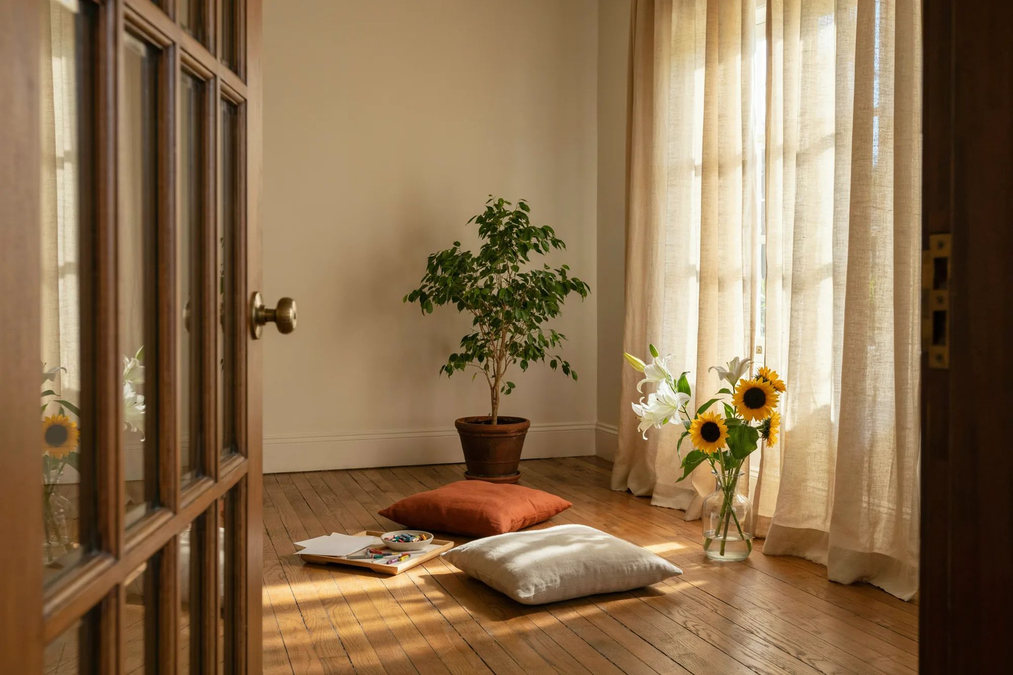 The practice room, ready for a session, with lilies and sunflowers by the window